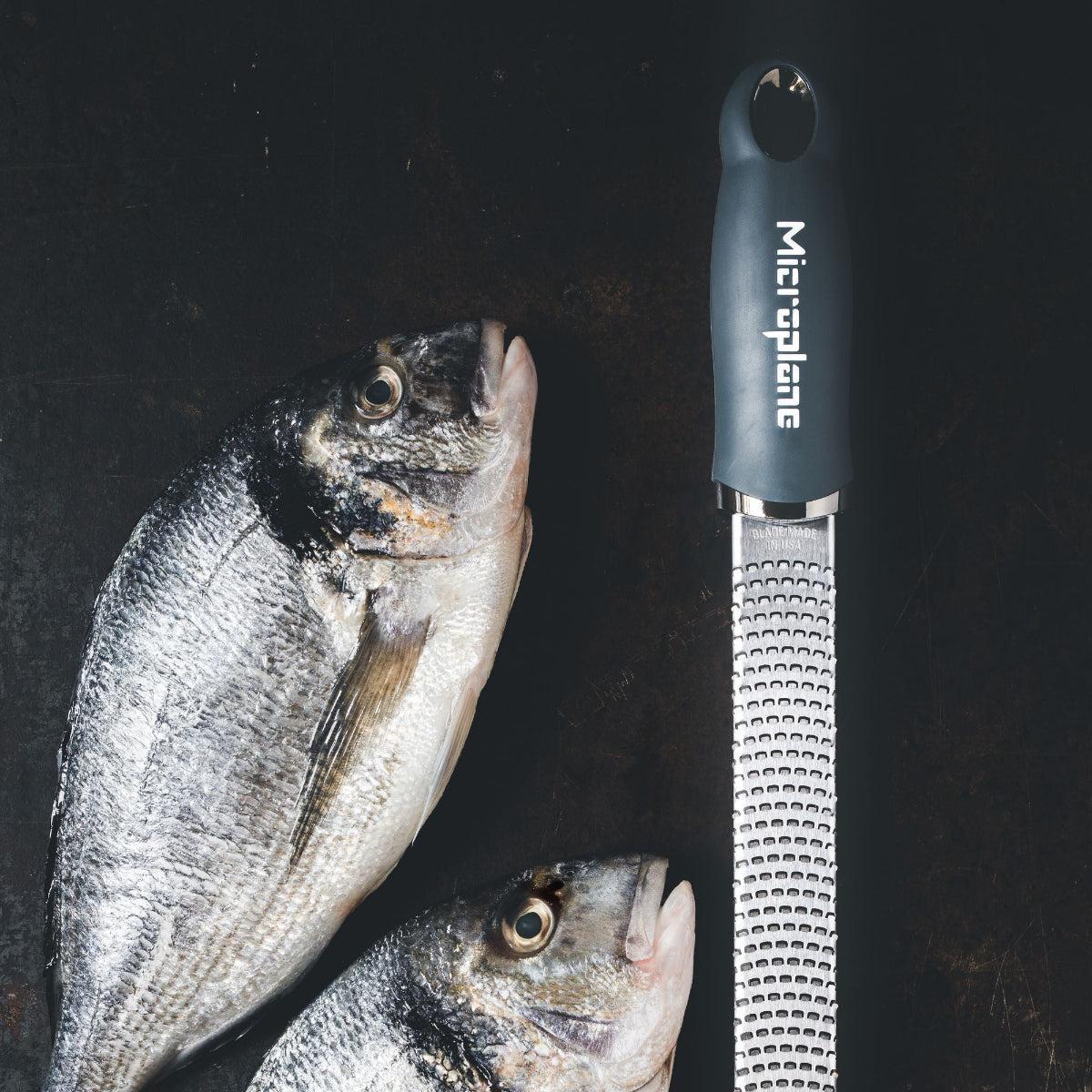 Microplane Gourmet Zester Grater Dark Grey with ergonomic handle and stainless steel fine blade for citrus, cheese, and spices