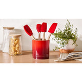 Le Creuset Spatula Set with Crock Cerise (5 Piece) | Minimax - on a table with plant