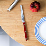 Sabre Bistrot Solid Tomato Knife Burgundy | Minimax - in table with tomato