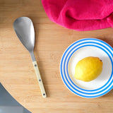 Sabre Bistrot Solid Rice Spoon Ivory 26cm | Minimax - with lemon on plate