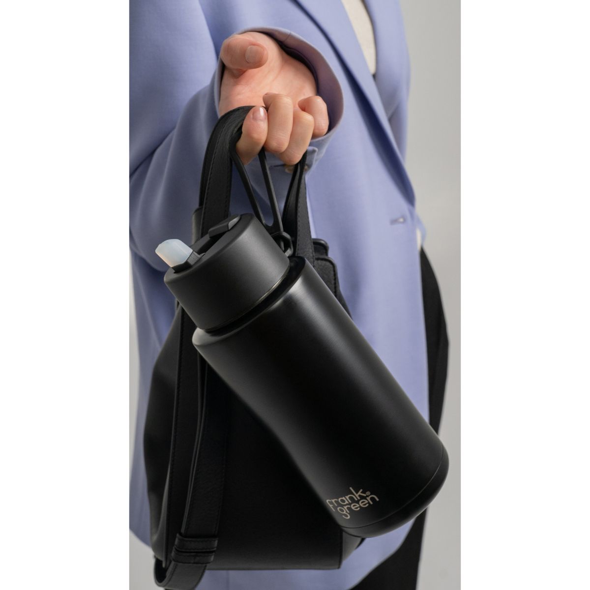 Frank Green Bottle with Flip Lid Midnight 1L | Minimax - with a woman holding