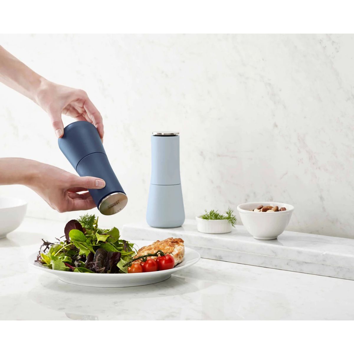 Joseph Joseph Milltop Salt & Pepper Mill Set Sky | Minimax - in a kitchen counter 