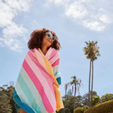 Dock & Bay Summer Collection Beach Towel Coastal Candy 90x160cm | Minimax - worn by a woman on the beach