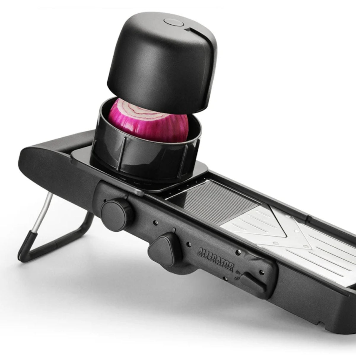 Alligator Mandoline Slicer Black, close-up of hand pressing safety holder with onion on slicing surface