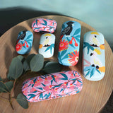 Annabel Trends Safe Keeper White Cockatoo  – Group of cases on table, including cockatoo, wildflower, and blossom designs