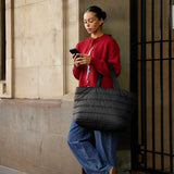 Base Supply Cloud Take It Base Black 56x35x18cm – lifestyle view, carried by a woman in a red cardigan.