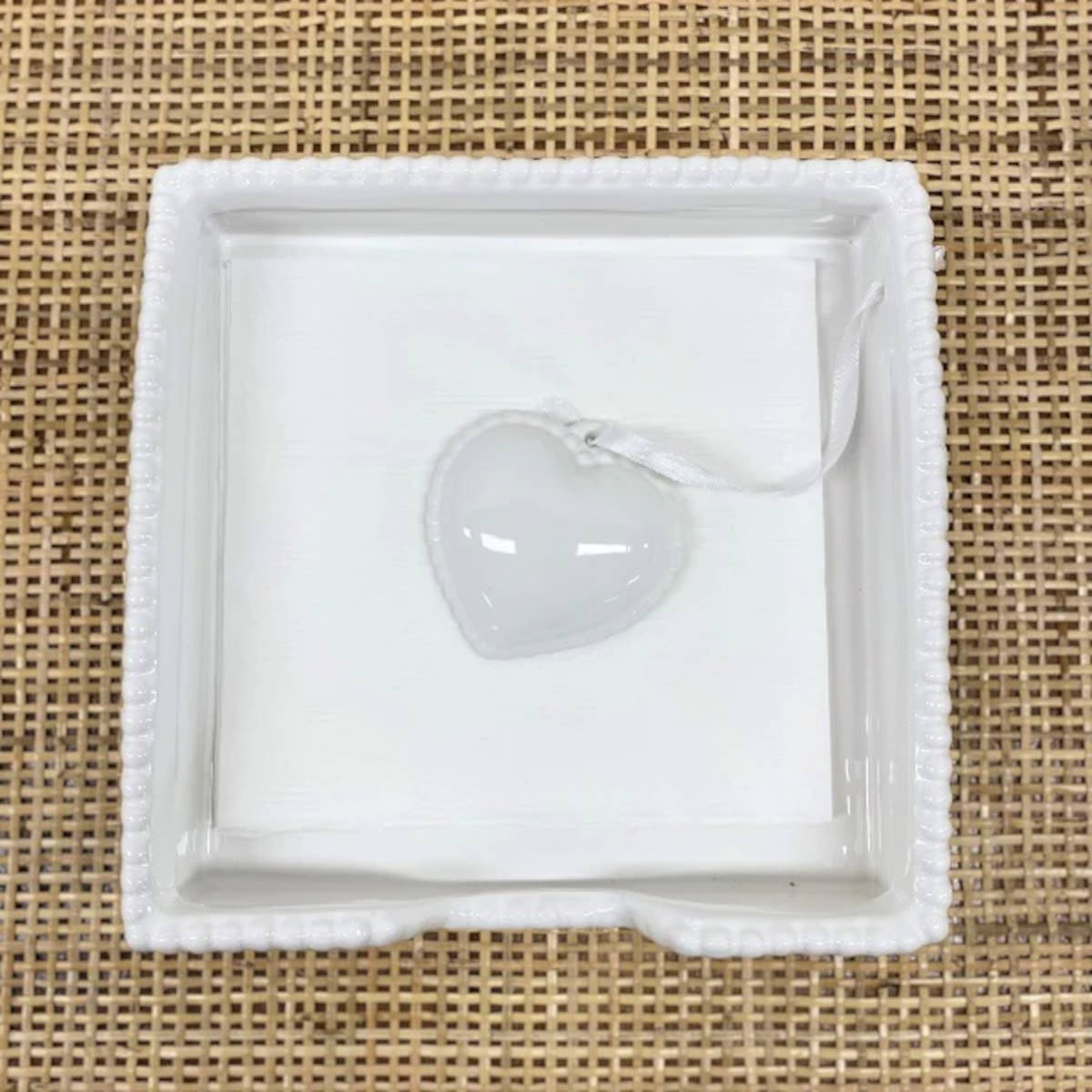 Ceramic Heart Napkin Holder White displayed with blue patterned napkins on wooden table