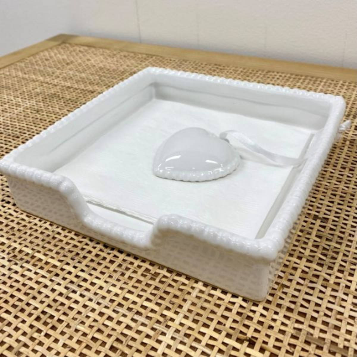 Ceramic Heart Napkin Holder White displayed with blue patterned napkins on wooden table