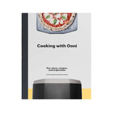 Cooking with Ooni Cookbook by Kristian Tapaninaho and Darina Garland, featuring Ooni pizza oven recipes, stories, and cooking inspiration