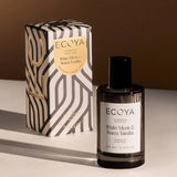 Ecoya Celebration Collection White Musk & Warm Vanilla Room Spray 100mL styled with its decorative gift box under warm lighting, showcasing the elegant festive packaging.