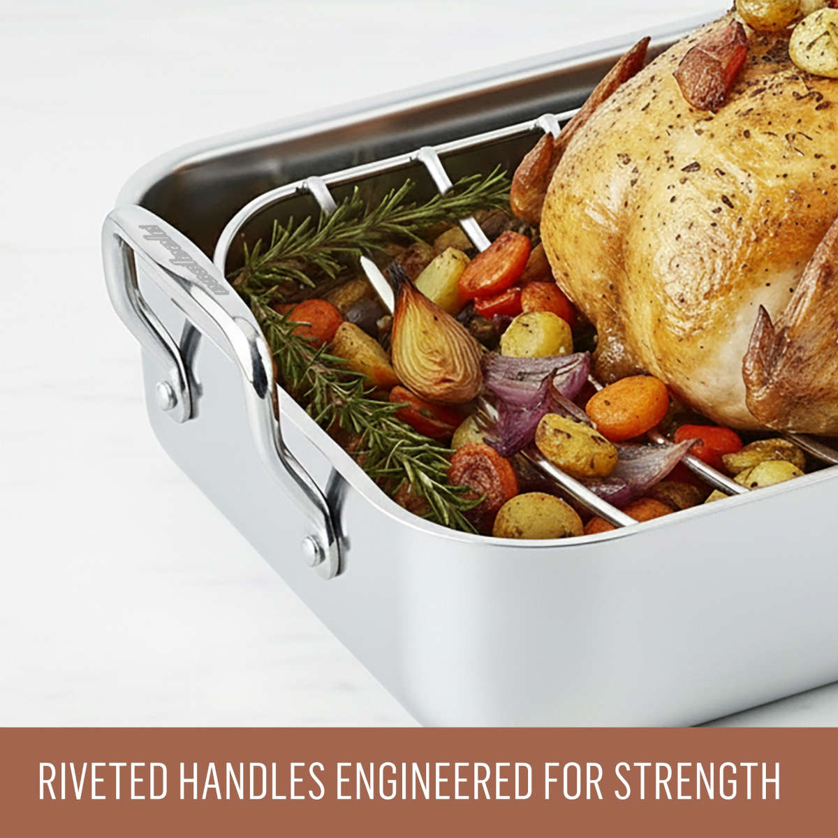 Close-up of Essteele Stainless Steel Roaster showing riveted handles and roast chicken inside