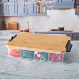 Farberware SnackleBox with Bamboo Board 30 x 40cm - Bamboo lid on a container with compartments filled with vegetables in a kitchen setting