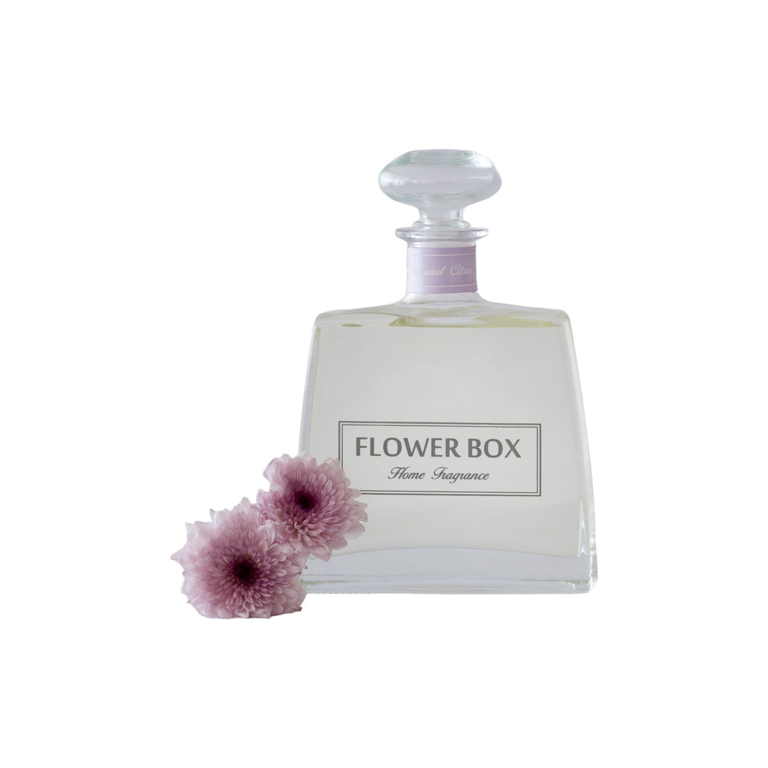 Minimalist glass diffuser bottle with soft floral accents for a refined home scent