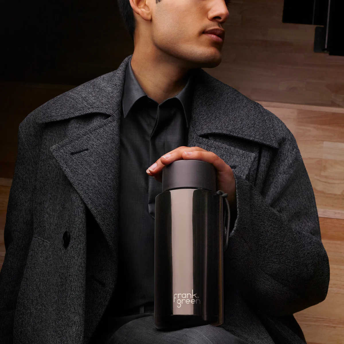 Frank Green Ceramic Reusable Bottle Shadow Chrome 1L – lifestyle shot held upright by model