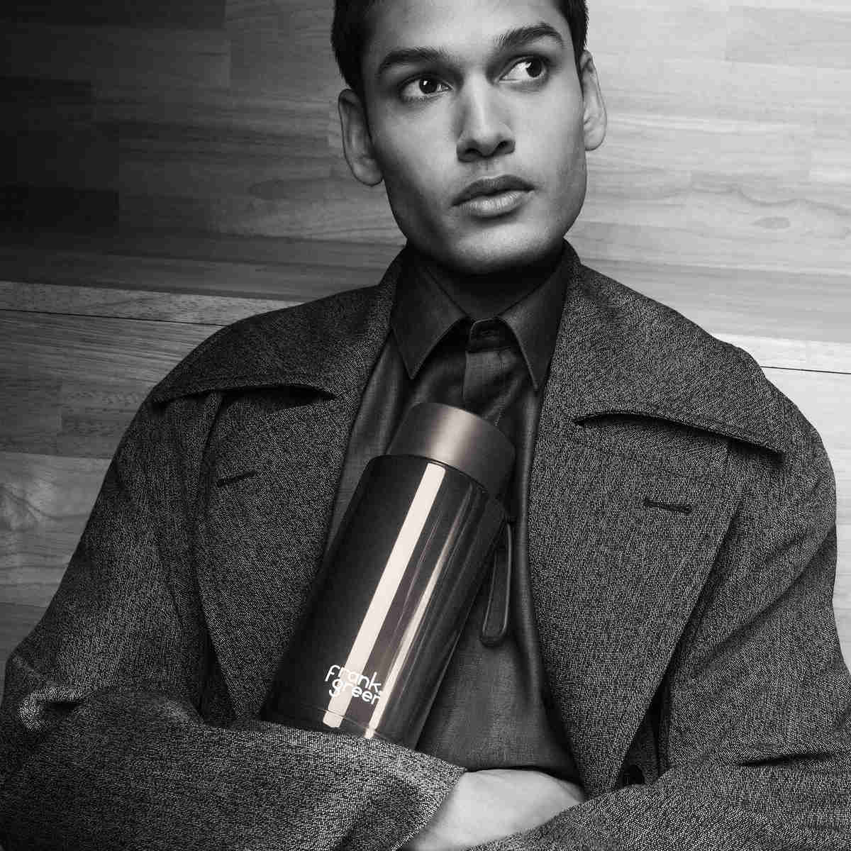 Frank Green Ceramic Reusable Bottle Shadow Chrome 1L – lifestyle shot held by model in grayscale