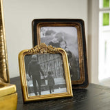 French Country Floral Shaped Frame 15x16cm – styled gold floral photo frame with black and white family photo on dark wood table