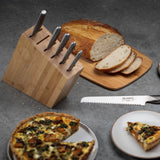 Global Kyoto knife block set with sliced bread on cutting board, bamboo block and stainless steel knives in kitchen setting