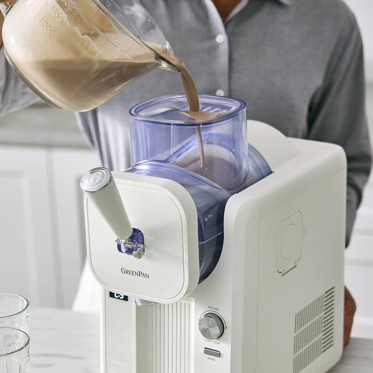 GreenPan Frost Ice-Cream & Slushie Maker Cream – lifestyle image with person pouring chocolate mix into top container