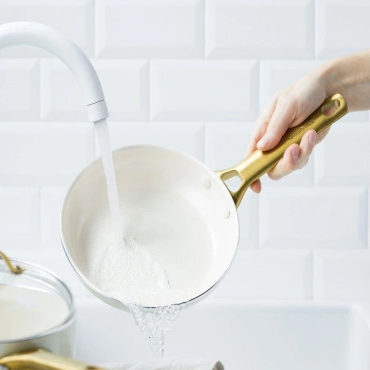 Image 1: GreenPan Padova Frypan Cream 20cm – rinsing effortlessly under water with gold handle detail