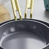 GreenPan Stanley Tucci Stainless Steel Frypan Set 20cm & 26cm with gold handles stacked together on white background