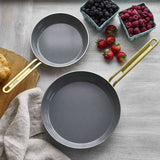 GreenPan Stanley Tucci Stainless Steel Frypan Set 20cm & 26cm with gold handles stacked together on white background