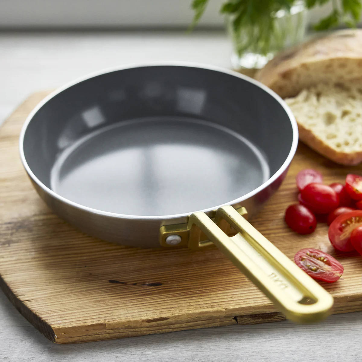 GreenPan Stanley Tucci Stainless Steel Frypan Set 20cm & 26cm with gold handles stacked together on white background