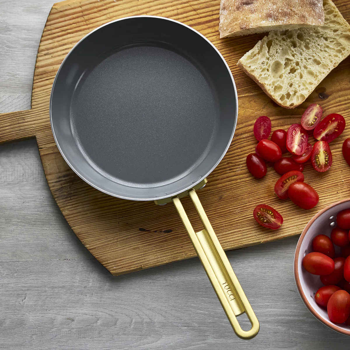 GreenPan Stanley Tucci Stainless Steel Frypan Set 20cm & 26cm with gold handles stacked together on white background