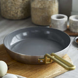 GreenPan Stanley Tucci Stainless Steel Frypan Set 20cm & 26cm with gold handles stacked together on white background