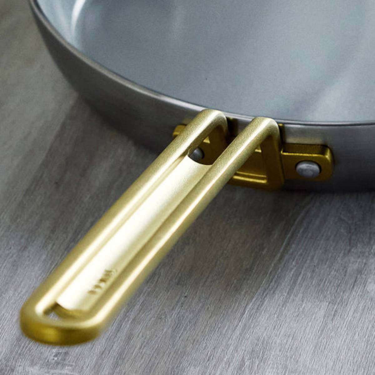 GreenPan Stanley Tucci Stainless Steel Frypan Set 20cm & 26cm with gold handles stacked together on white background