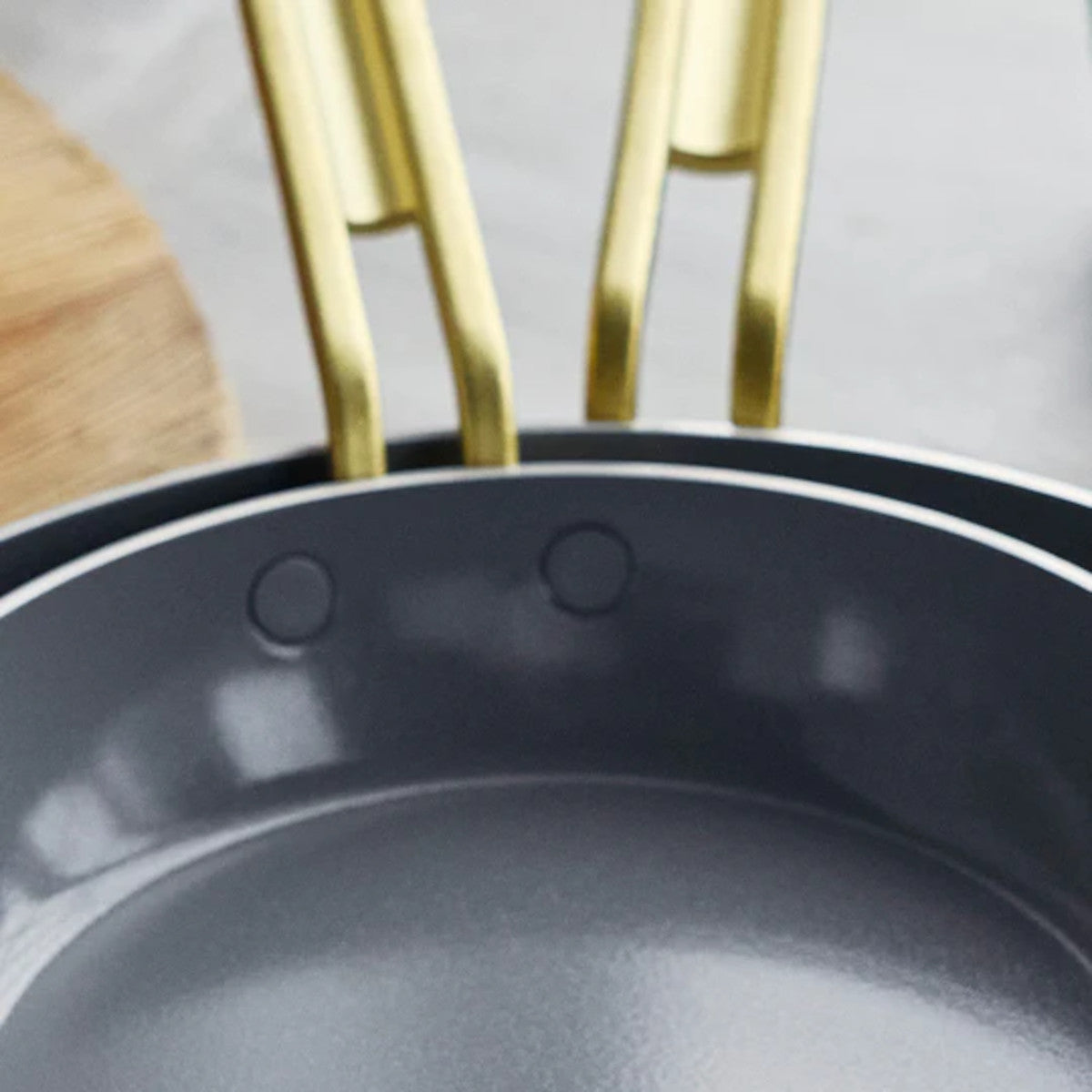 GreenPan Stanley Tucci Stainless Steel Frypan Set 20cm & 26cm with gold handles stacked together on white background