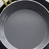 GreenPan Stanley Tucci Stainless Steel Frypan Set 20cm & 26cm with gold handles stacked together on white background