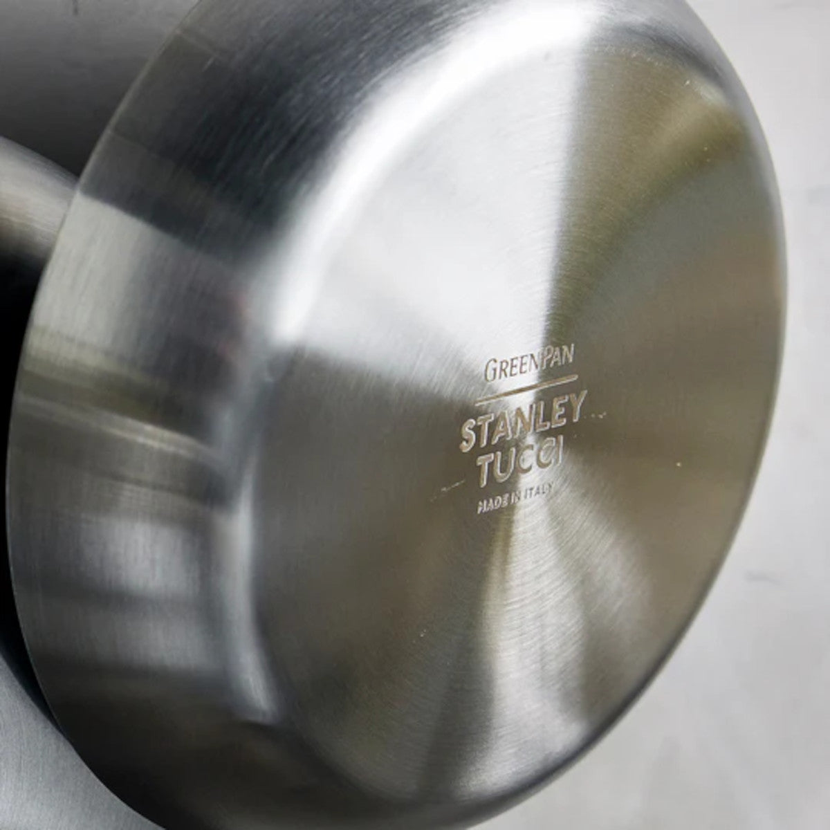 GreenPan Stanley Tucci Stainless Steel Frypan Set 20cm & 26cm with gold handles stacked together on white background