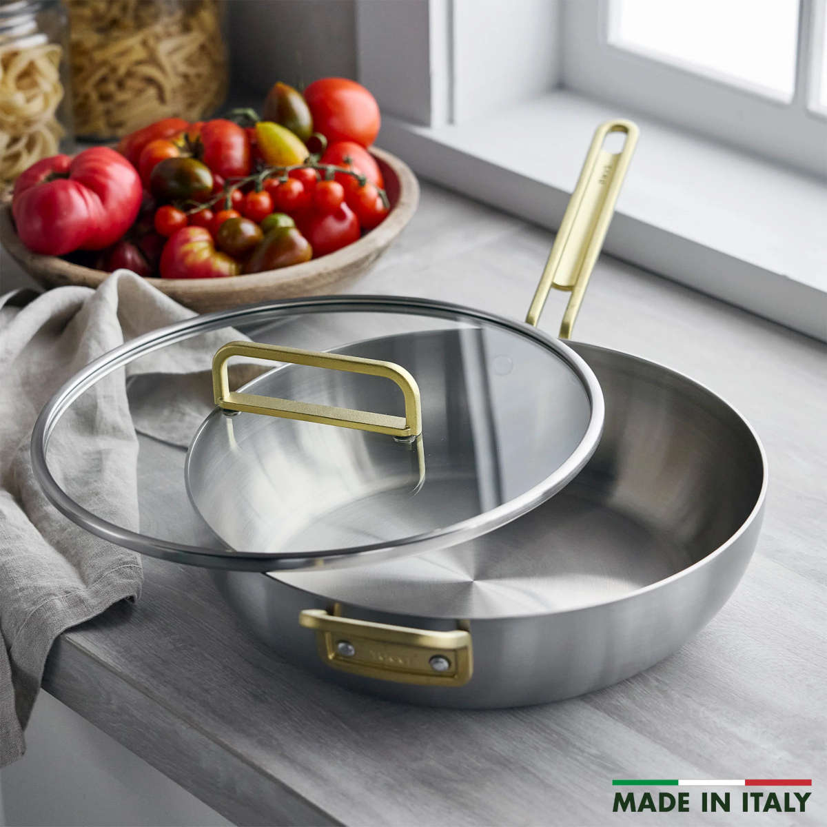 GreenPan Stanley Tucci Stainless Steel Stanley Pan 33cm (6.2L) with glass lid and gold handles on white background
