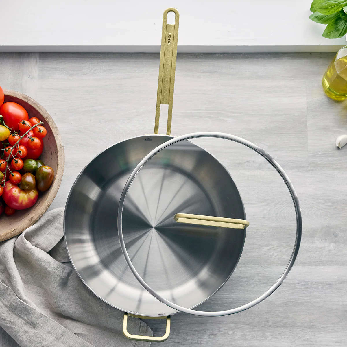 GreenPan Stanley Tucci Stainless Steel Stanley Pan 33cm (6.2L) with glass lid and gold handles on white background