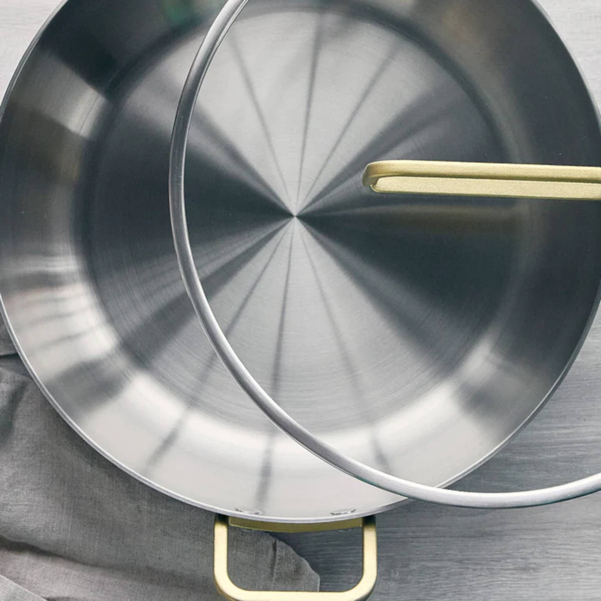 GreenPan Stanley Tucci Stainless Steel Stanley Pan 33cm (6.2L) with glass lid and gold handles on white background