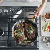 GreenPan Padova Stainless Steel Frypan 20cm – overhead view cooking steaks with rosemary