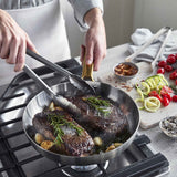 GreenPan Padova Stainless Steel Frypan 28cm – on stovetop with food cooking inside