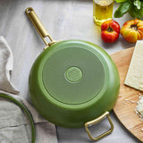 GreenPan Stanley Tucci Pan Junior Green – bottom view with logo beside cheese and tomatoes