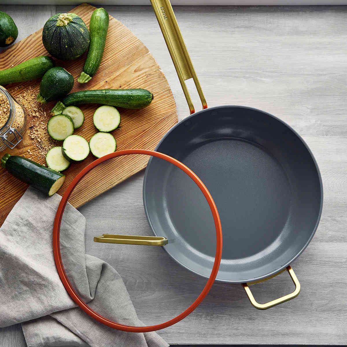 GreenPan Stanley Tucci Pan Junior Orange – overhead shot with lid off and sliced zucchini