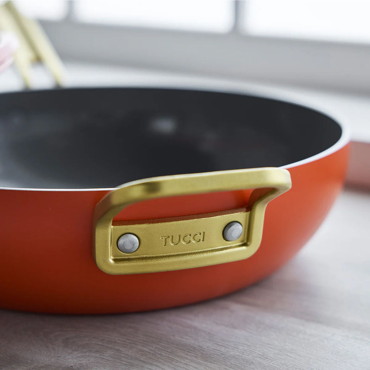 GreenPan Stanley Tucci Pan Junior Orange – close-up gold side handle detail