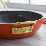 GreenPan Stanley Tucci Pan Junior Orange – close-up gold side handle detail