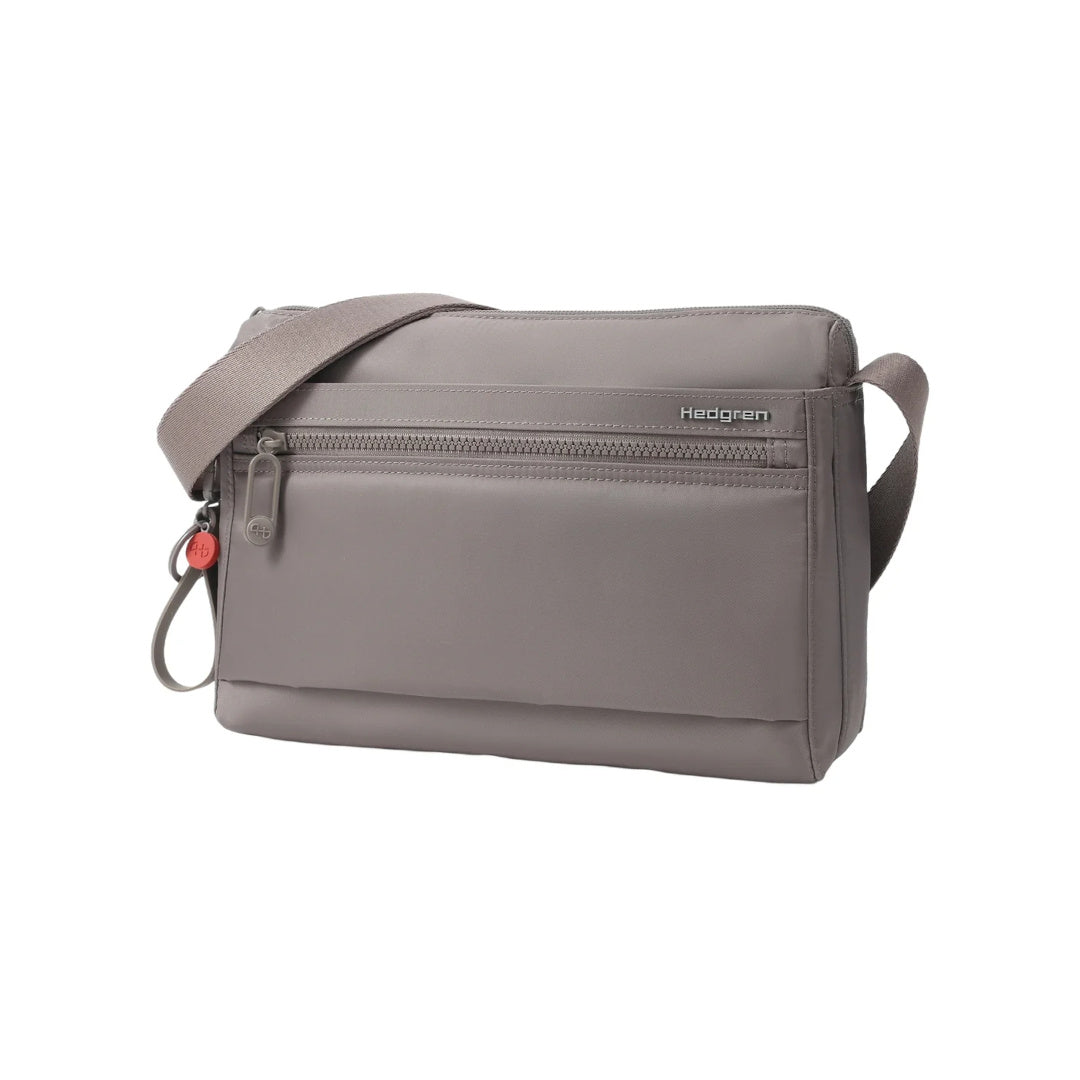 Three-quarter front angle of the Hedgren Inner City Eye Neo Crossbody showcasing the front zip pocket, subtle branding, and streamlined silhouette.