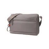 Three-quarter front angle of the Hedgren Inner City Eye Neo Crossbody showcasing the front zip pocket, subtle branding, and streamlined silhouette.