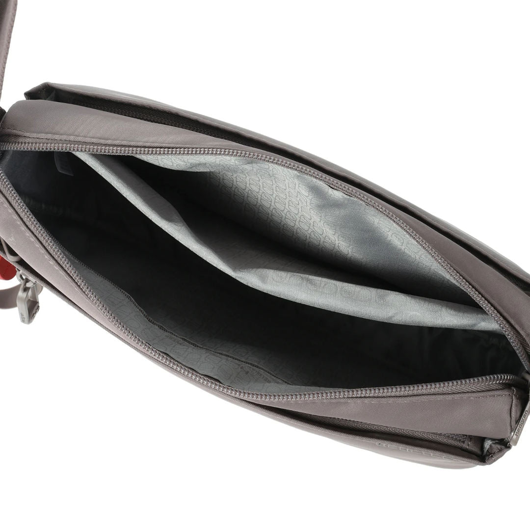 Top-down view of the Hedgren Inner City Eye Neo Crossbody, revealing the spacious main compartment with an internal slip pocket and patterned lining.