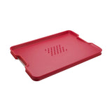 Joseph Joseph Cut & Carve Plus Multi-function Chopping Board Red XL with angled cutting surface, spikes, and juice-catching edges