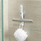 Squeegee stored neatly on wall hook with shower loofah hanging below