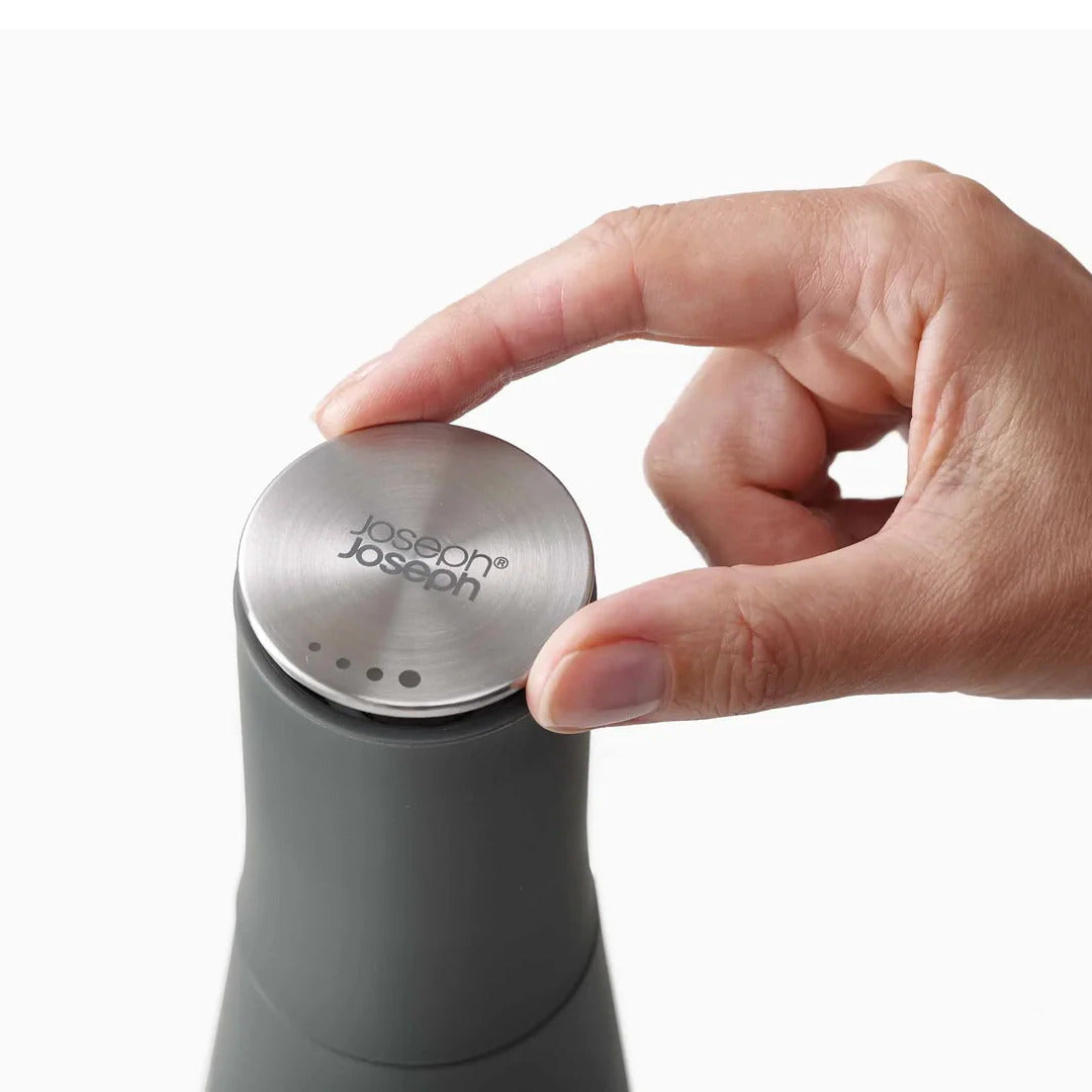 Adjustable stainless steel top for controlling grind size