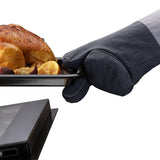 Joseph Joseph Pinch oven glove holding tray with roasted chicken and lemon