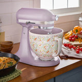 Lifestyle image of KitchenAid mixer in use on kitchen bench with ingredients