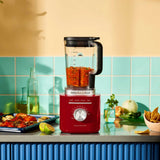 KitchenAid K200 Pure Power Blender Empire Red – Blending vegetables on a kitchen counter